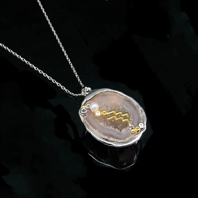 Aquarius crystal geode zodiac pendant with Aquarius symbol, angled view