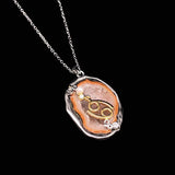 Cancer crystal geode zodiac pendant with Cancer symbol, angled view