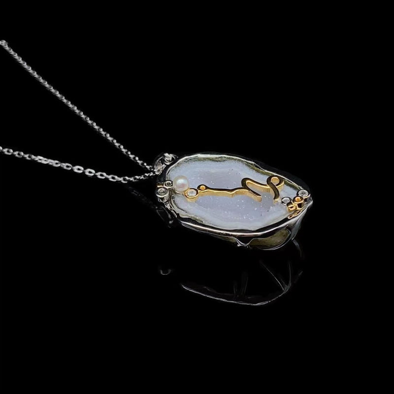 Capricorn crystal geode zodiac pendant with Capricorn symbol, angled view
