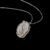 Capricorn crystal geode zodiac pendant with Capricorn symbol, angled view