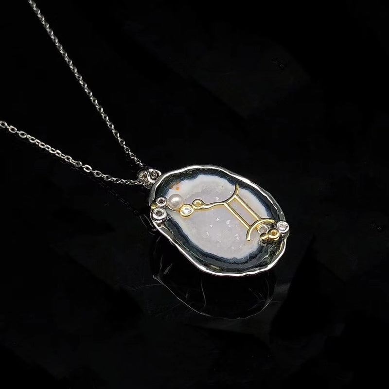 Gemini crystal geode zodiac pendant with Gemini symbol, angled view