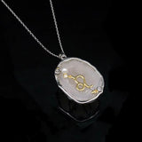 Leo crystal geode zodiac pendant with Leo symbol, angled view