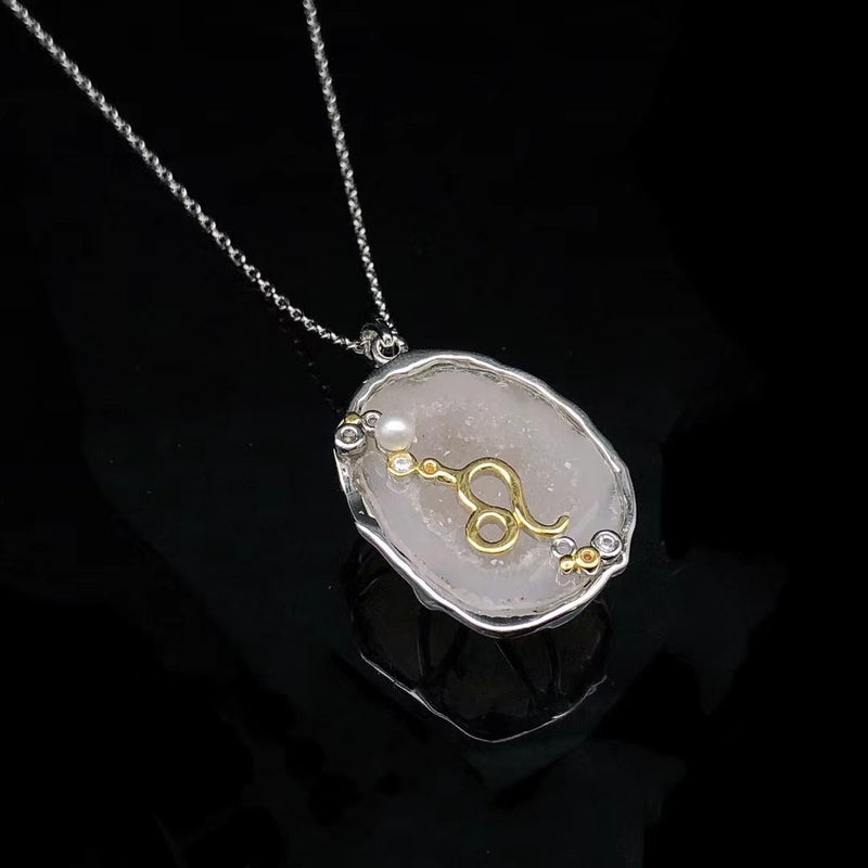 Leo crystal geode zodiac pendant with Leo symbol, angled view