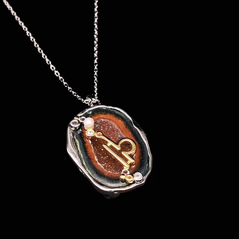 Libra crystal geode zodiac pendant with Libra symbol, angled view