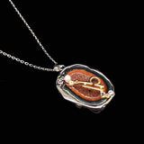 Libra crystal geode zodiac pendant with Libra symbol, angled view