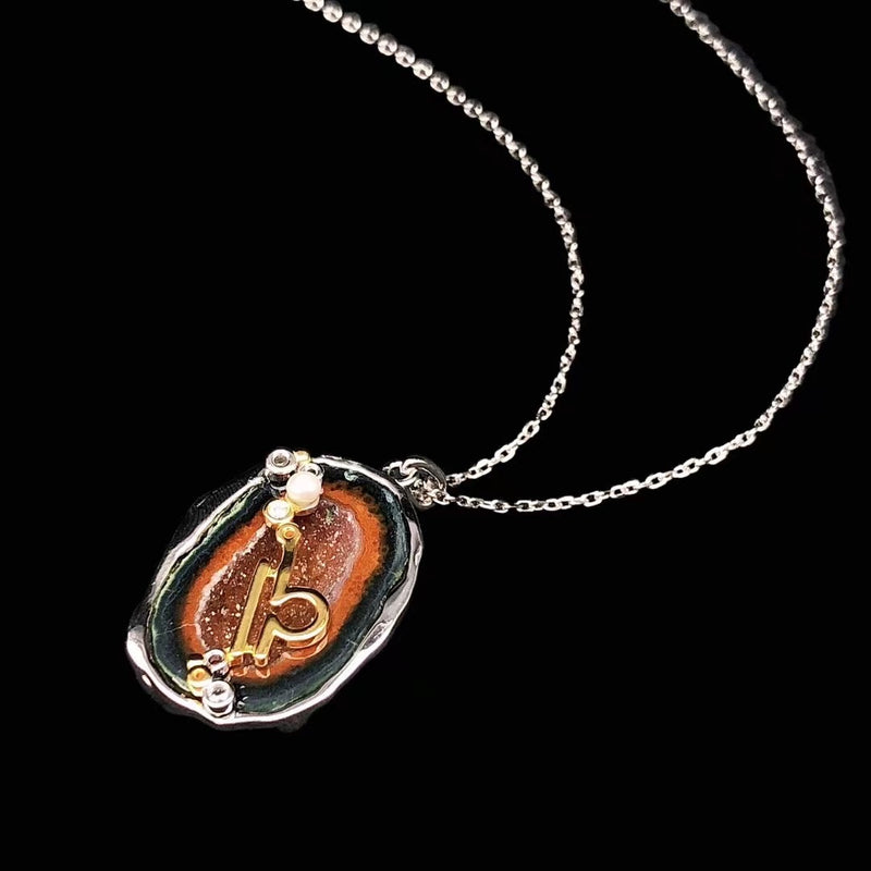 Libra crystal geode zodiac pendant with Libra symbol, angled view